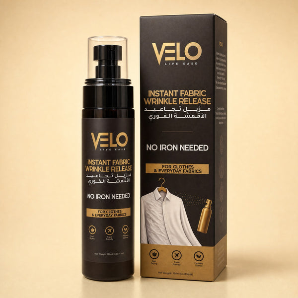 VELO Live Ease Instant Fabric Wrinkle Release spray bottle and its retail box, both in black with gold lettering, set against a warm beige background.